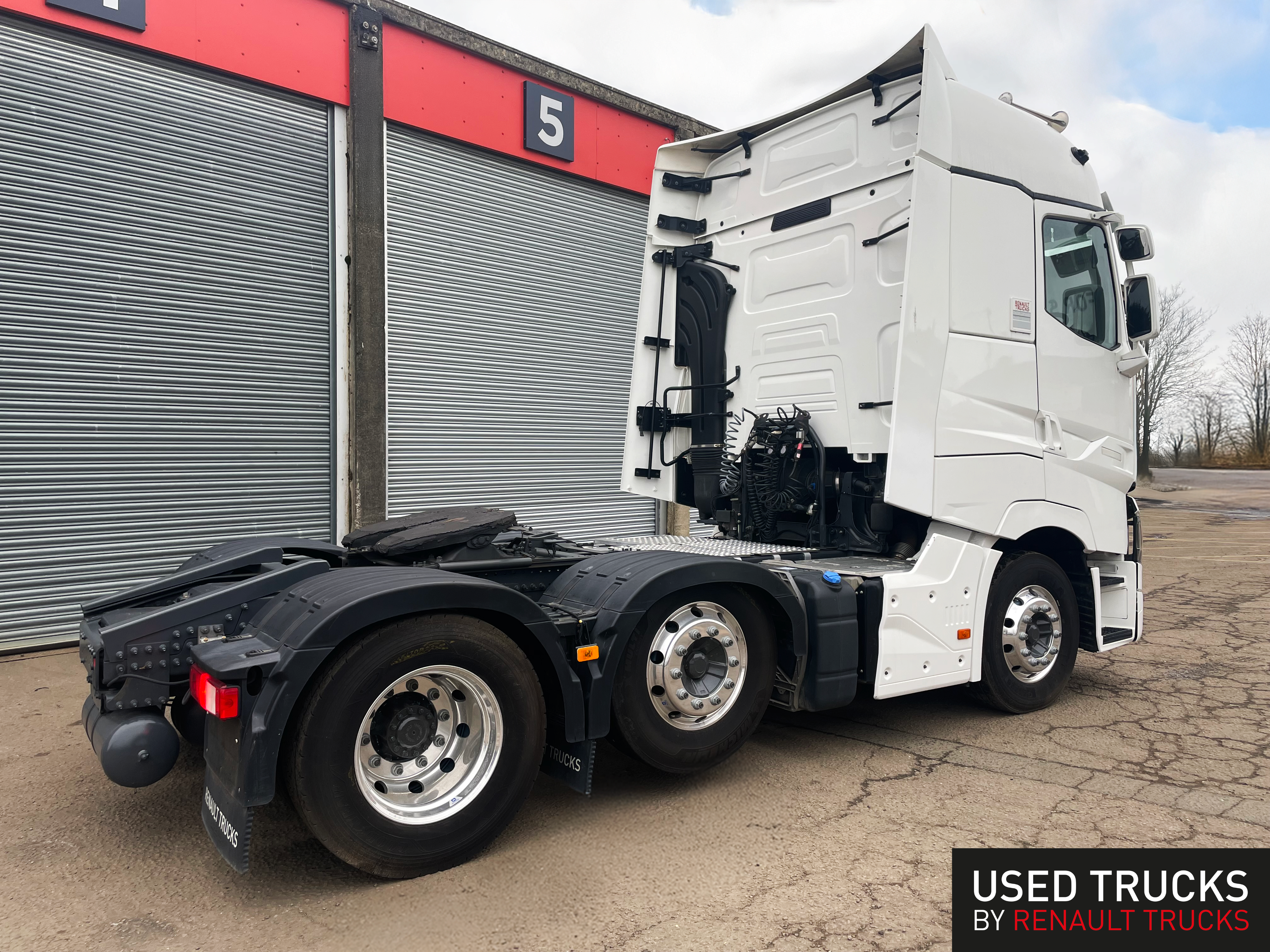 Used Renault T High 6x2 tractor unit - rear angle view showing axle configuration, chrome wheels, and chassis details - white cab with factory specifications - available at Norfolk Truck & Van