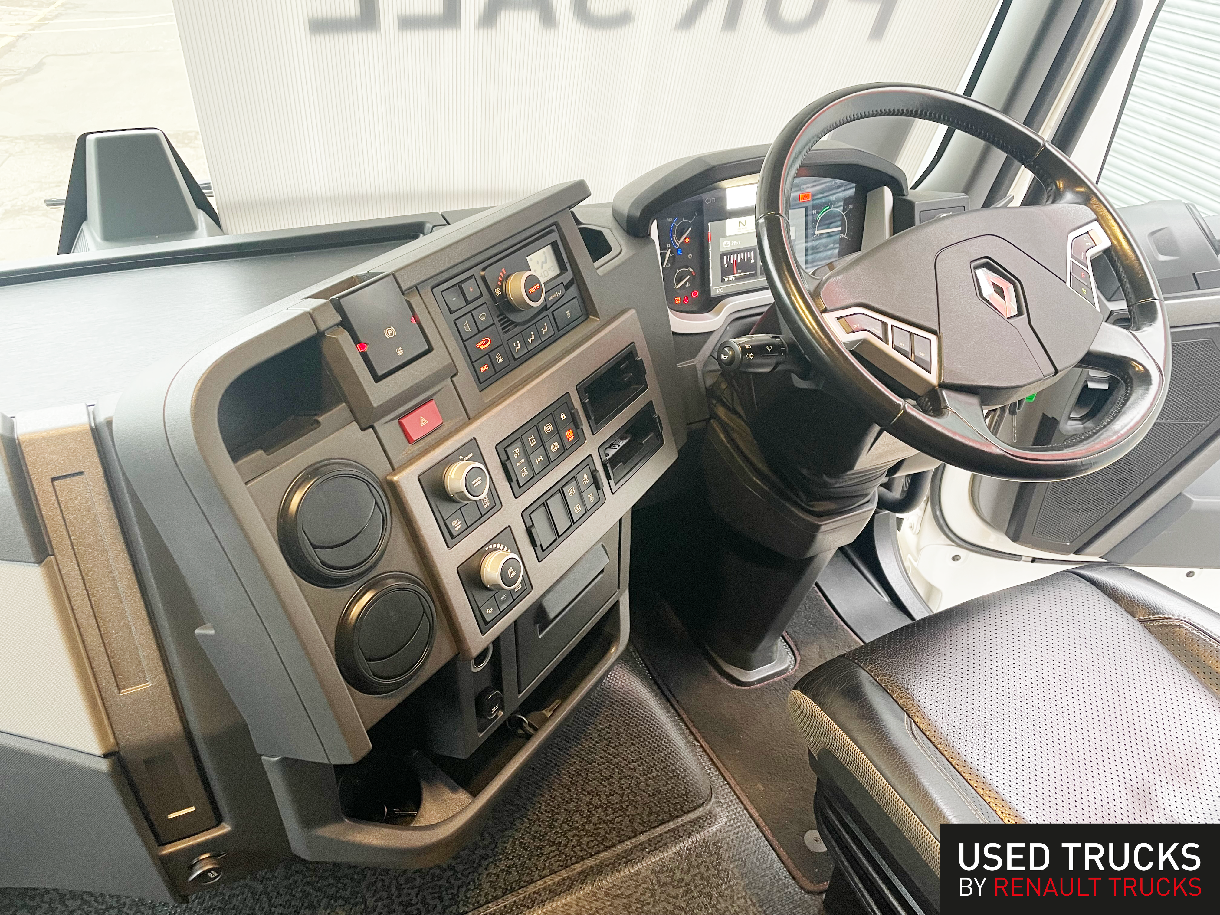 Renault T High interior showing leather steering wheel, digital dashboard display, center console controls and premium cab specification - used truck for sale at Norfolk Truck & Van - 2021 model in excellent condition