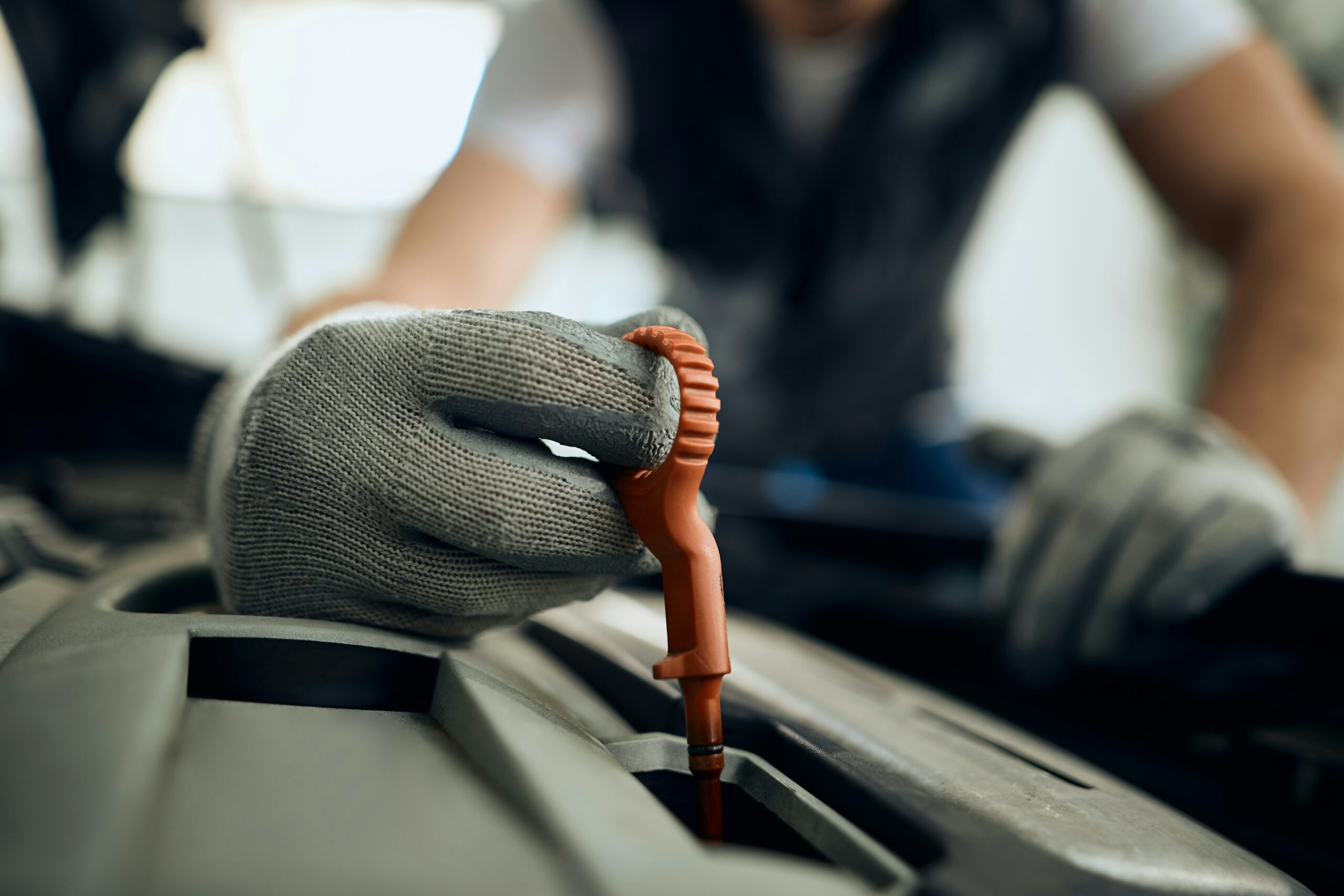 Photo of mechanic changing oil in van engine