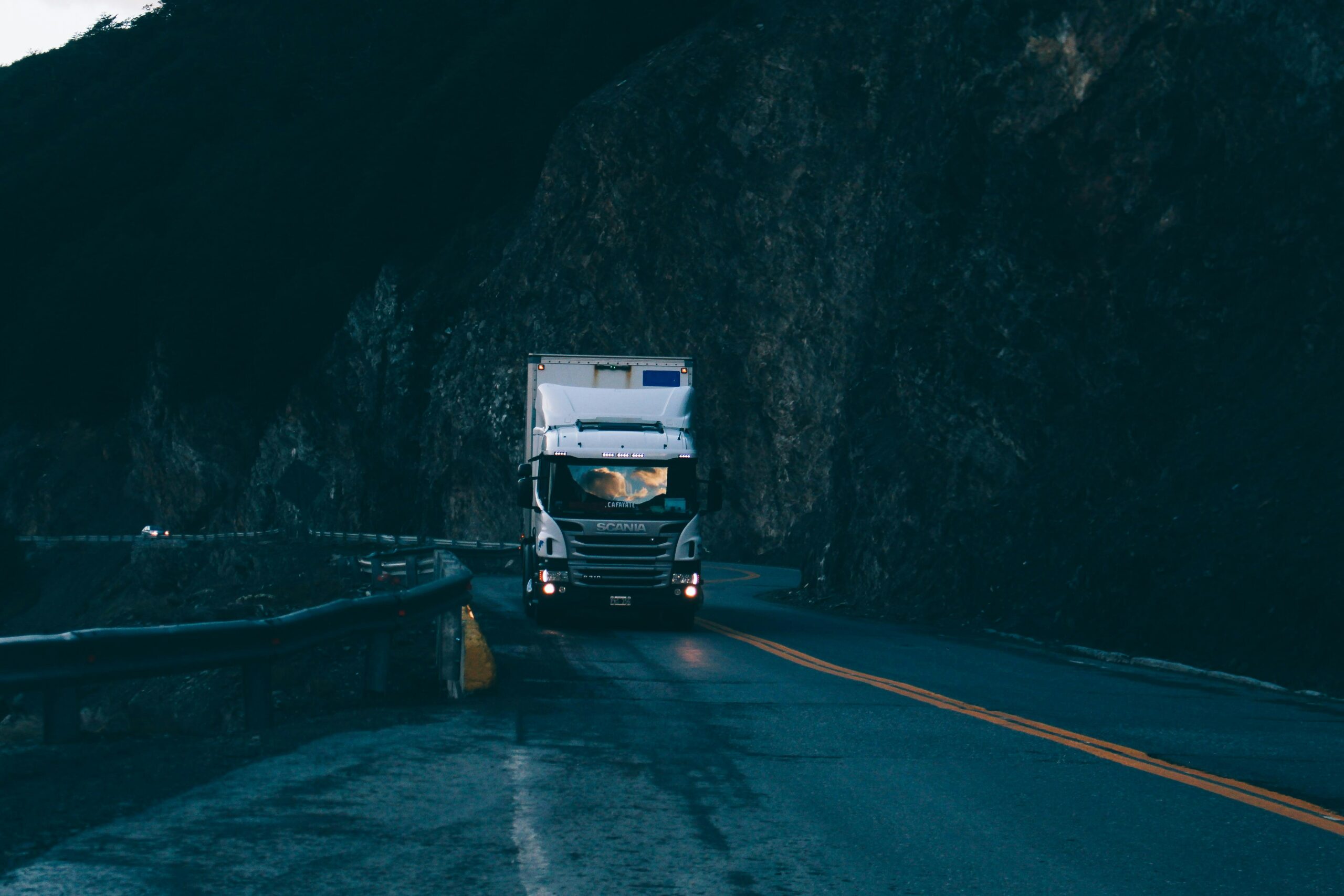 Truck driving along road in the dark