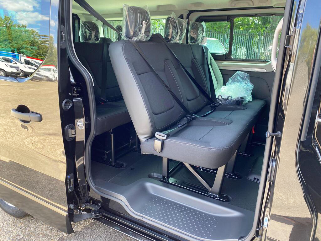 Middle row passenger seats inside Renault Trucks Trafic Combi minibus, designed for comfort and space