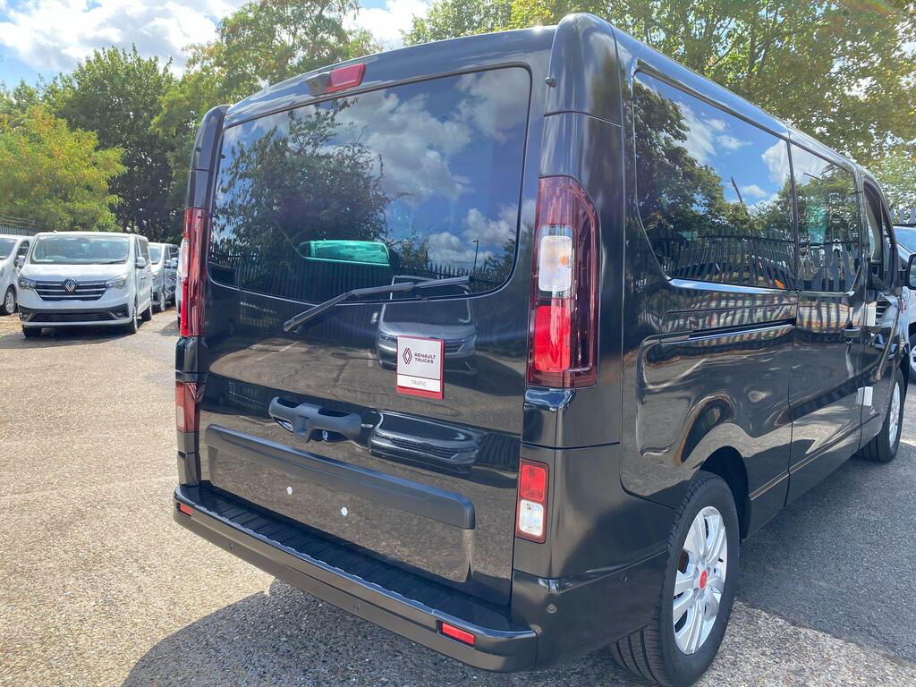 Rear three-quarter view of black Renault Trucks Trafic Combi minibus with twin rear doors