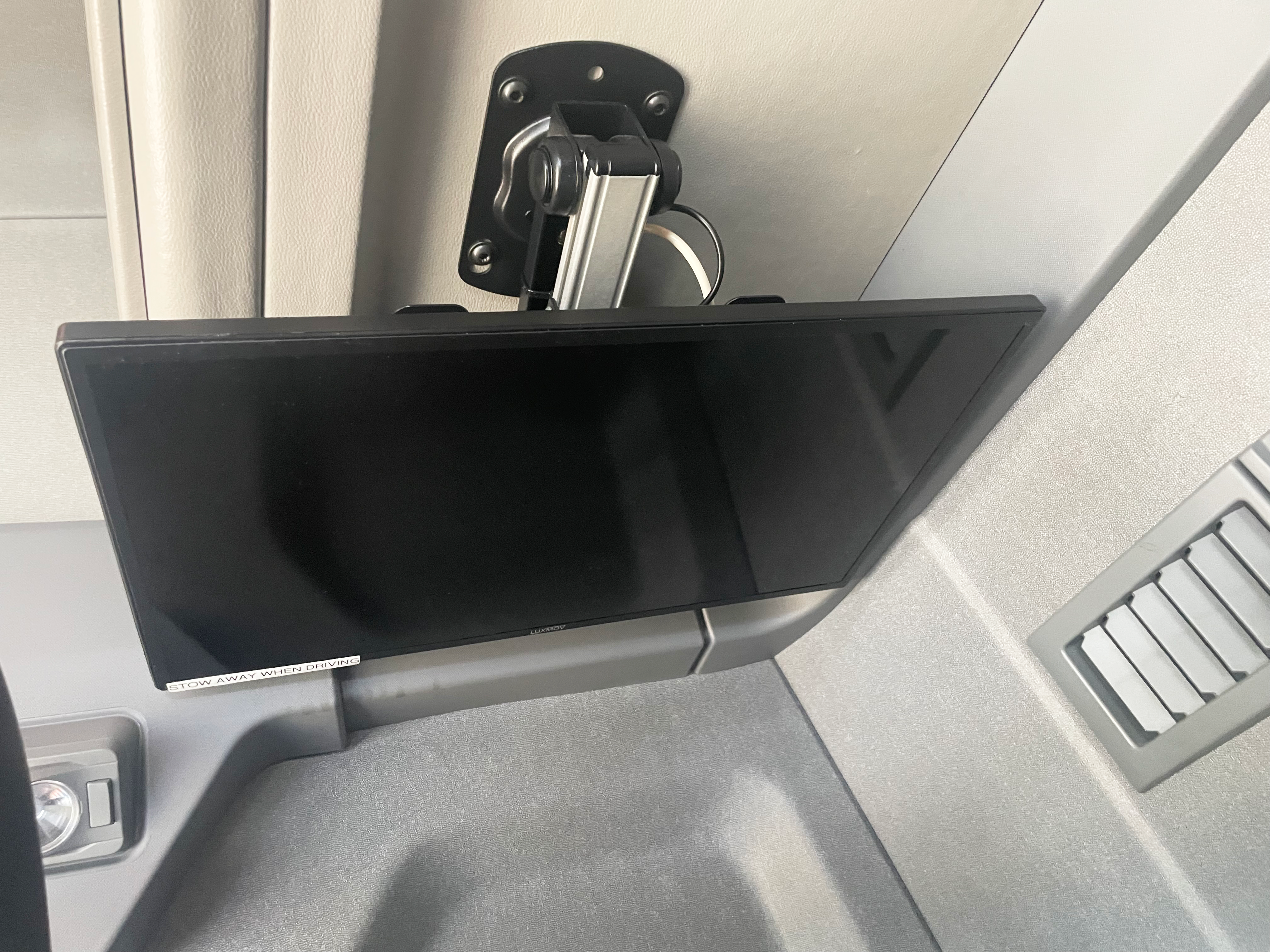 Flat-screen TV mounted in sleeper cab of Renault Trucks T 6x2 Euro 6, labelled "Stow away when driving."
