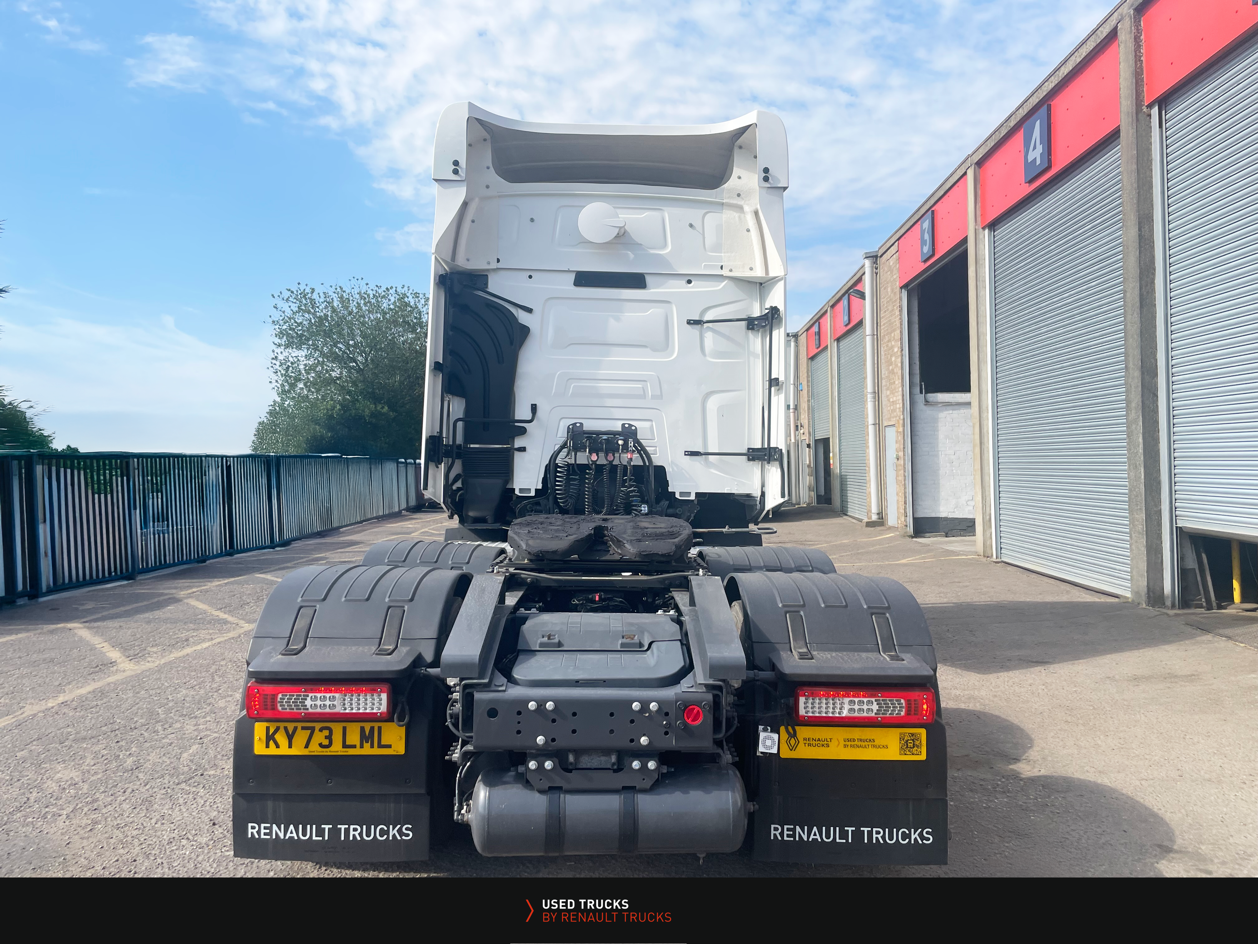 Rear view of a Renault Trucks T480 6x2 tractor unit showing twin rear axles, trailer coupling, and lighting setup.