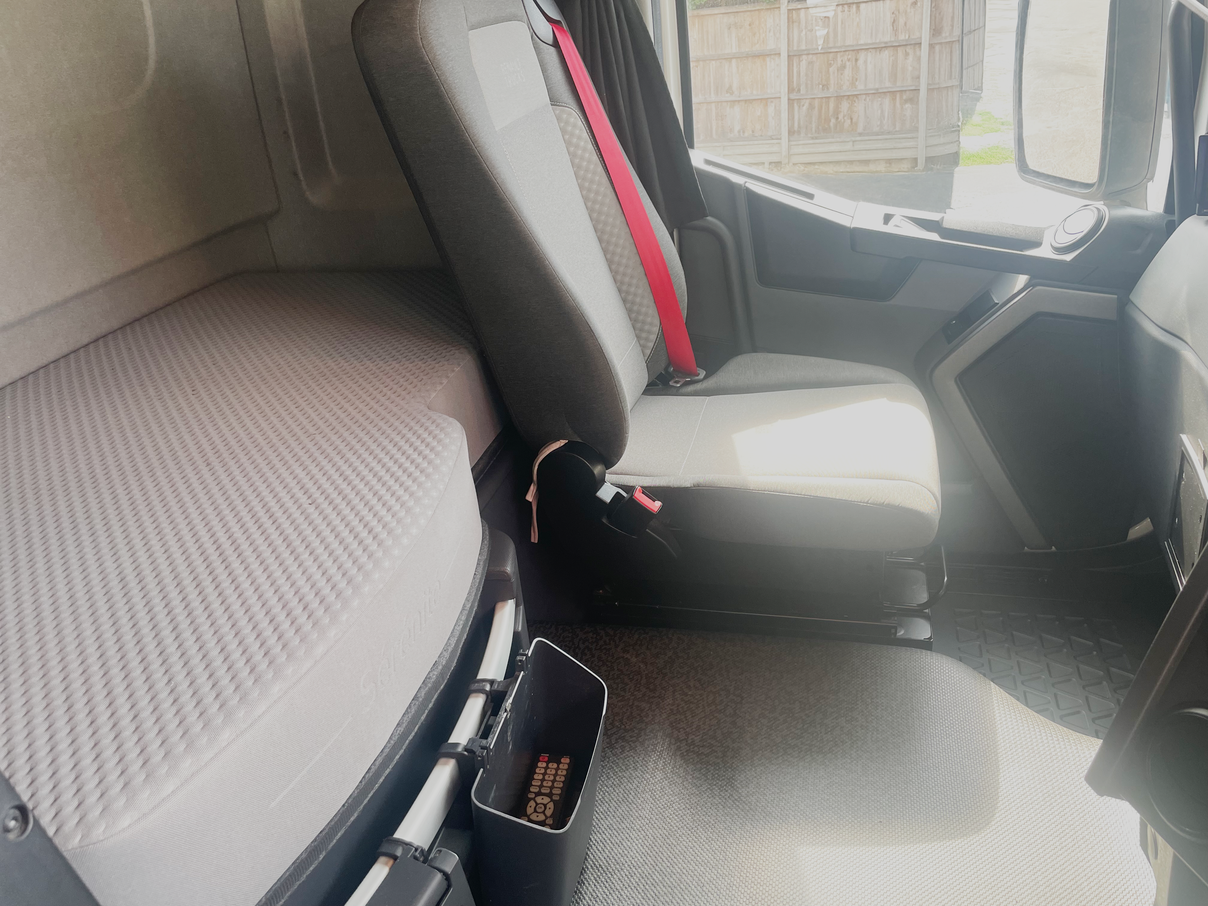 Passenger seat and surrounding cab interior in Renault Trucks T 6x2 Euro 6, highlighting upholstery and spacious design.