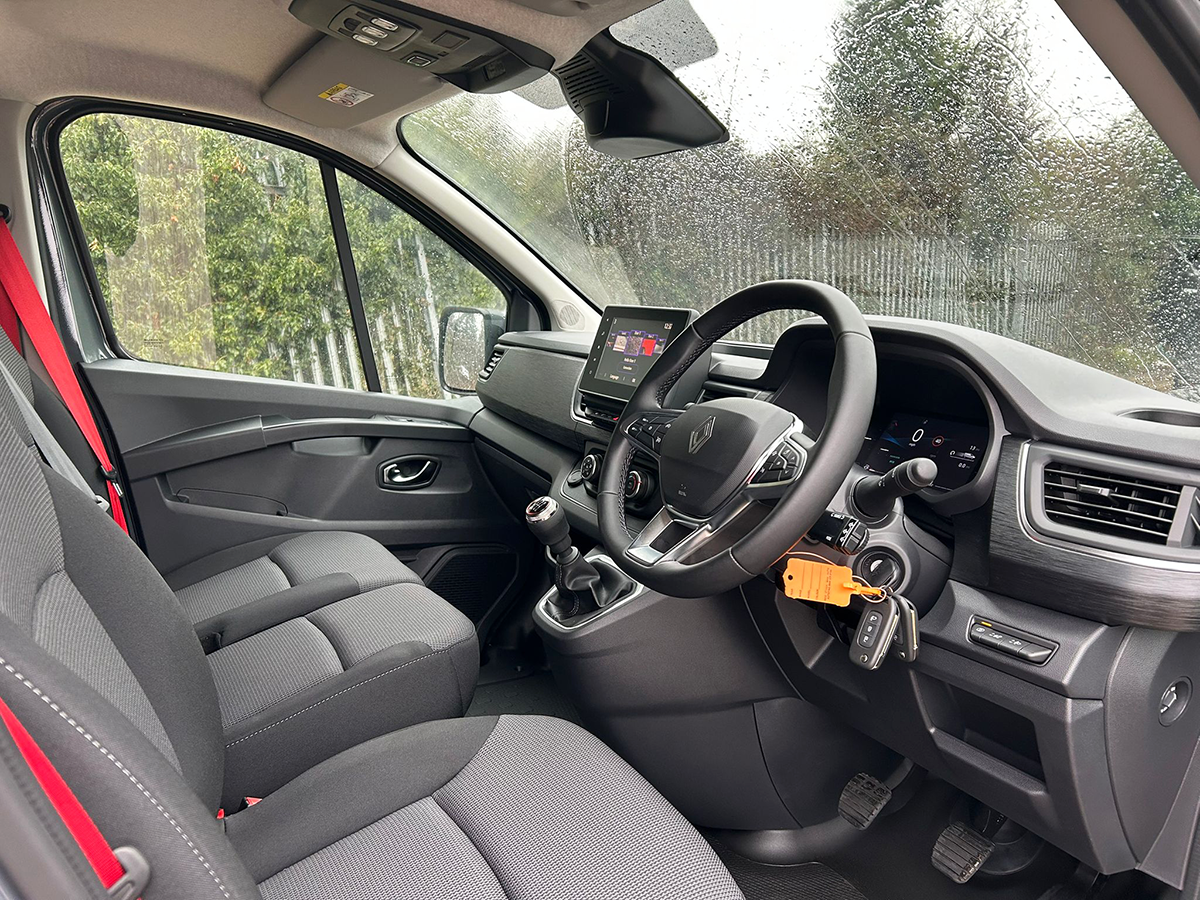 Renault Trafic Red Edition cab interior from driver’s side showing dashboard, steering wheel and multimedia display