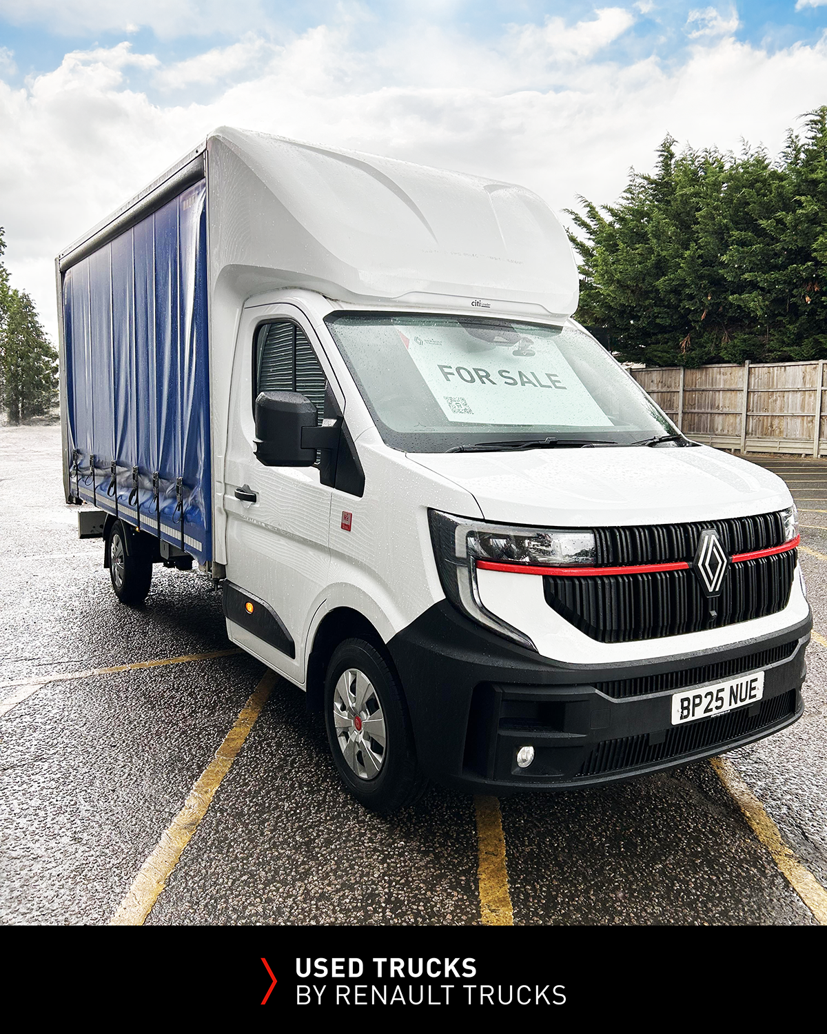 Used Renault Master 150 L3 curtainsider van with blue side curtains and tail lift viewed from the front corner.