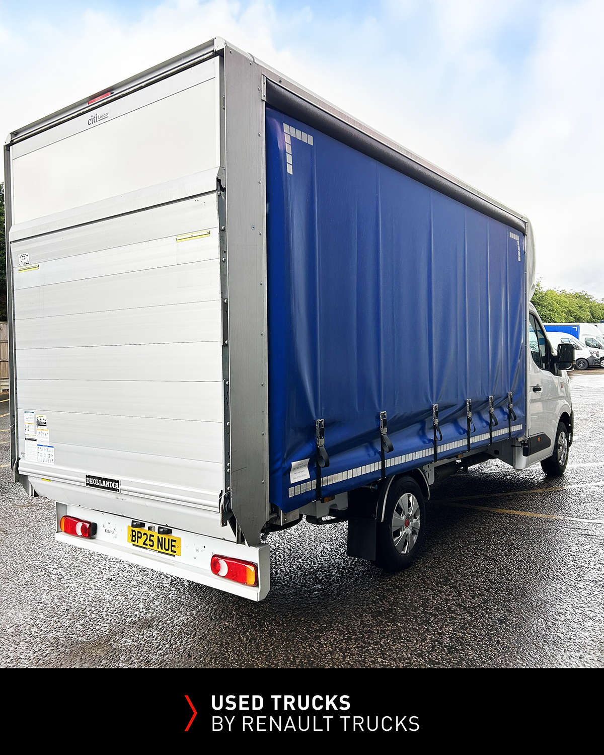 Rear angle view of a Renault Master 150 curtainsider with aluminium rear shutter and tail lift platform.
