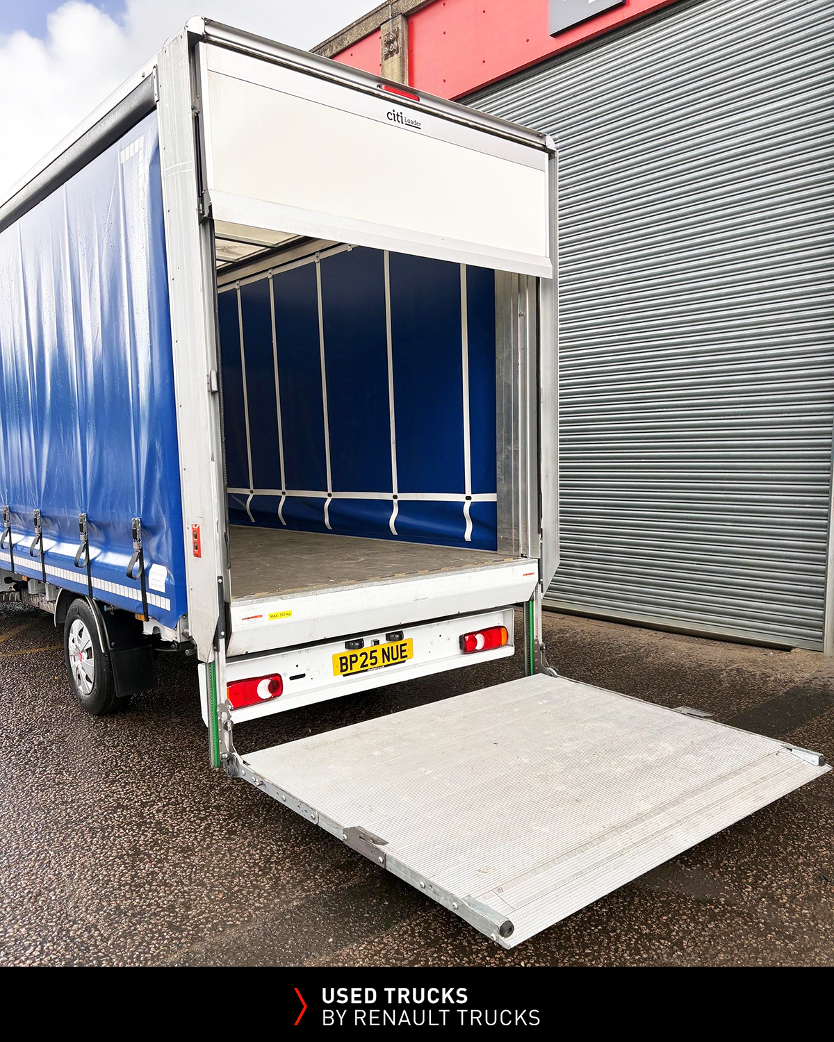 Renault Master curtainsider with rear shutter raised and tail lift lowered for easy loading and unloading.