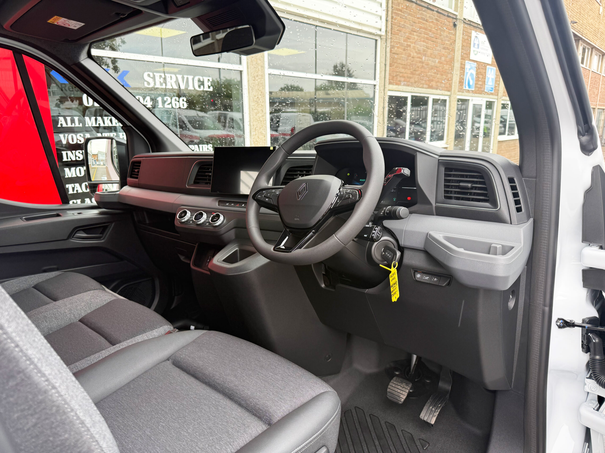 Interior of the Renault Master E-Tech Red Edition chassis cab showing the driver's cockpit, digital display and dashboard